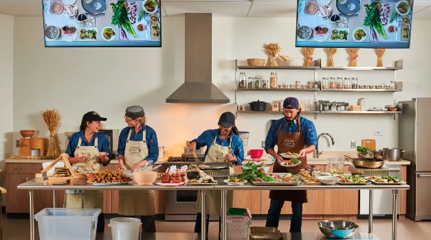 Chefs preparing food together in a teaching kitchen
